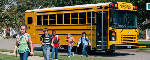 children getting off school bus